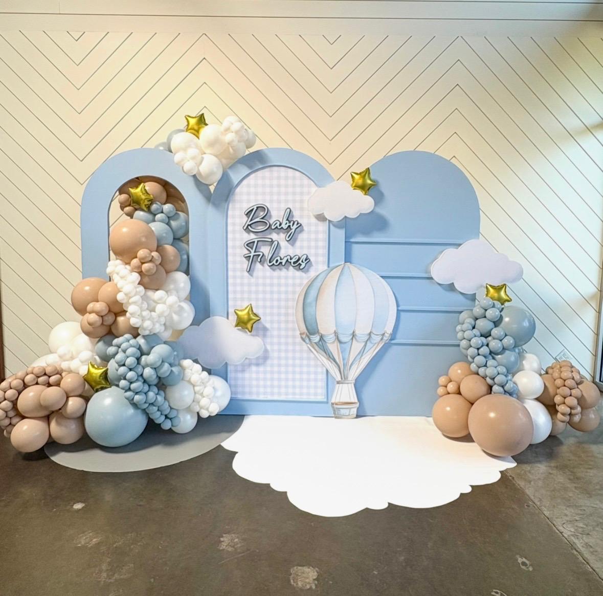 Baby shower backdrop with blue clouds, balloons, stars, and a hot air balloon