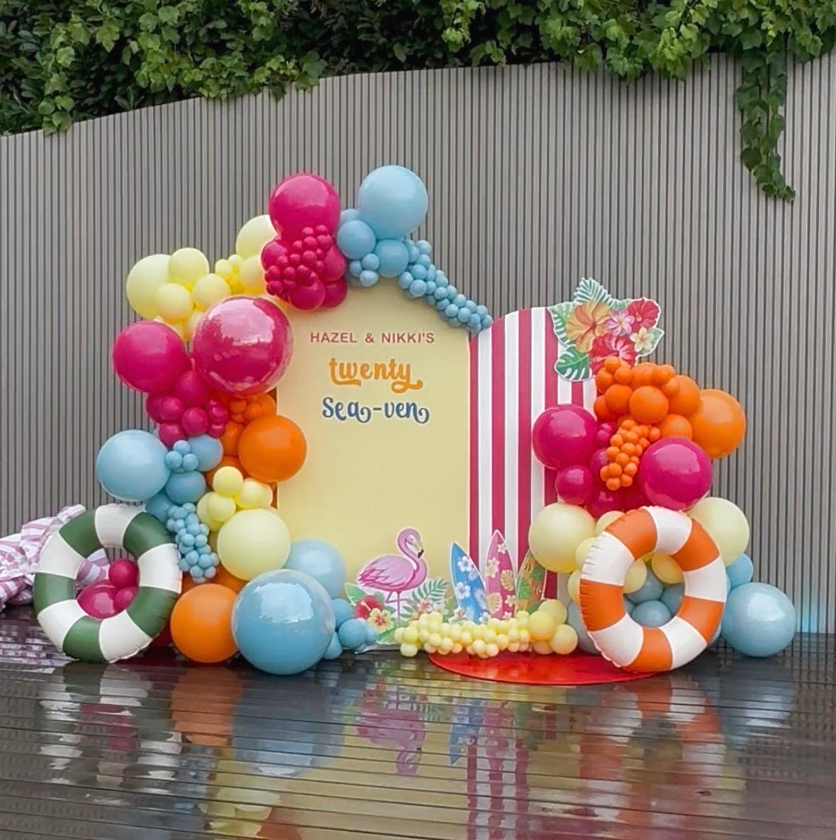 Colorful tropical birthday backdrop and balloon installation